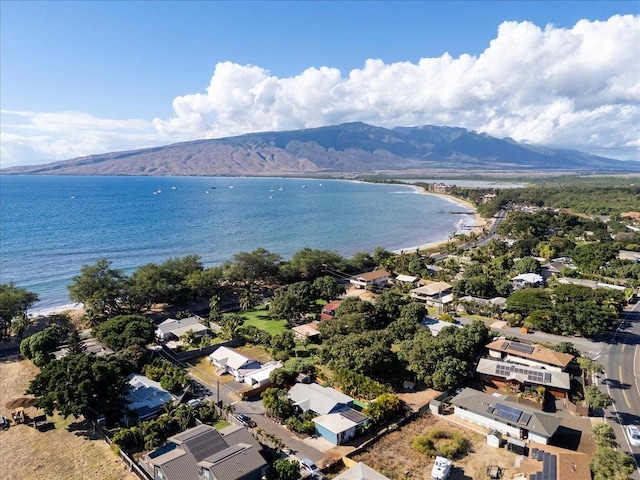 birds eye view of property with a water and mountain view