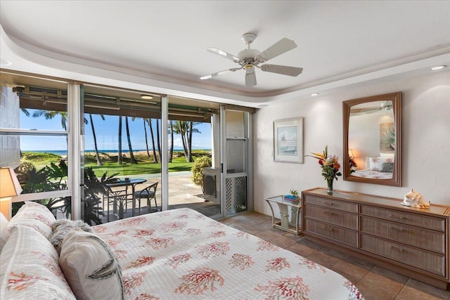 bedroom with ceiling fan, a raised ceiling, and access to outside