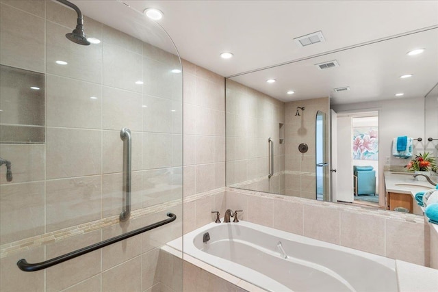 bathroom with vanity and separate shower and tub