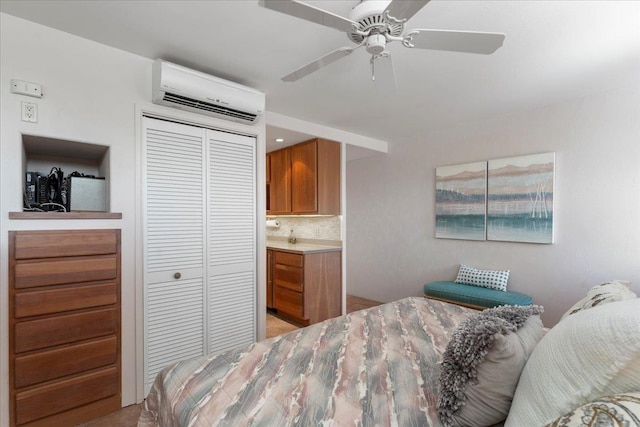 carpeted bedroom featuring an AC wall unit, ceiling fan, and a closet