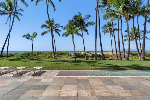 view of property's community with a water view and a yard