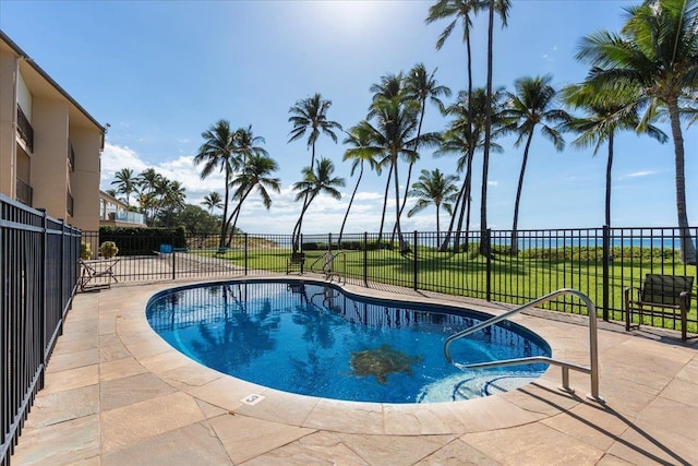 view of pool with a yard and a patio