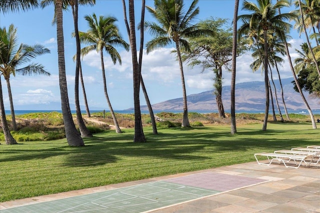 surrounding community featuring a mountain view and a lawn