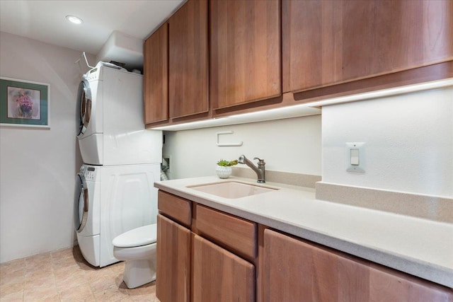 bathroom with vanity, toilet, and stacked washer / dryer