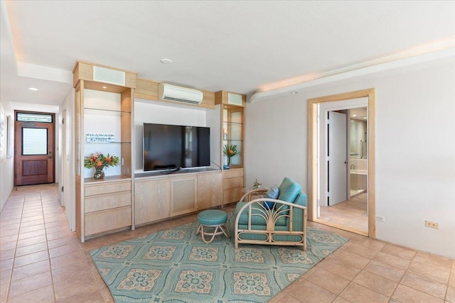 living room with a wall unit AC and light tile patterned floors