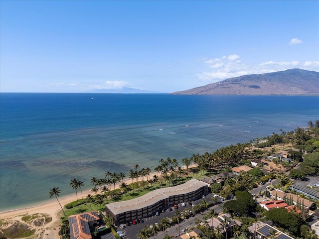 drone / aerial view with a beach view and a water and mountain view