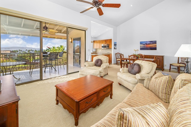 carpeted living room with ceiling fan and lofted ceiling