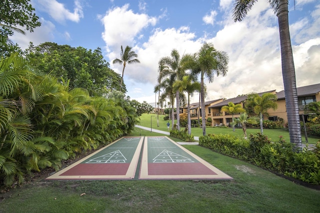 view of property's community featuring a yard