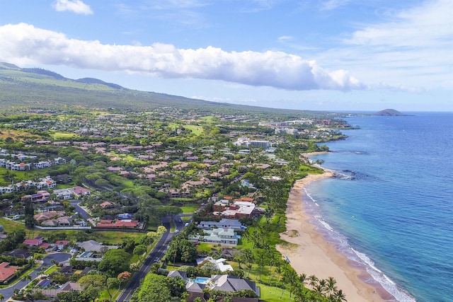 drone / aerial view featuring a water view and a view of the beach