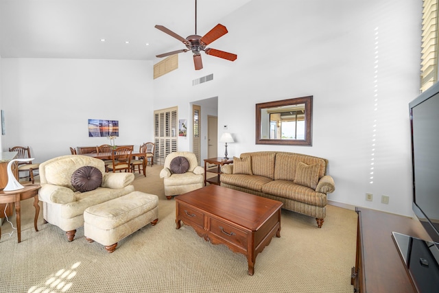 living room with a high ceiling and ceiling fan