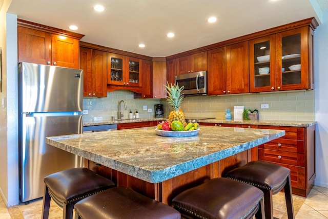 kitchen with recessed lighting, decorative backsplash, appliances with stainless steel finishes, and a sink