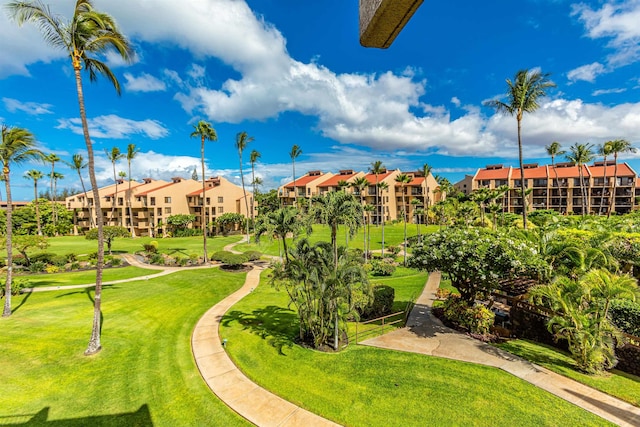 view of home's community with golf course view and a lawn
