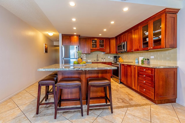 kitchen featuring appliances with stainless steel finishes, tasteful backsplash, and recessed lighting