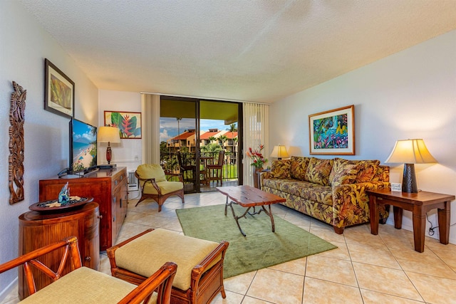 living area featuring light tile patterned floors, expansive windows, and a textured ceiling