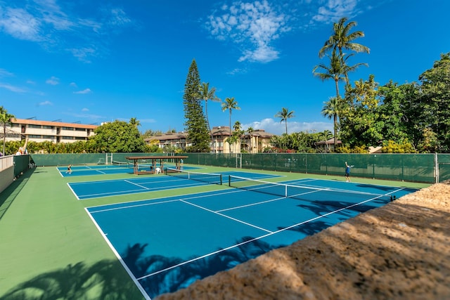 view of tennis court featuring fence