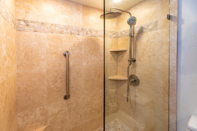 bathroom featuring toilet and tiled shower