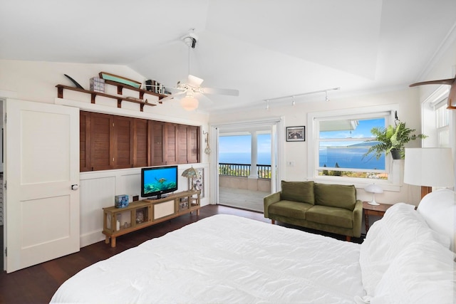 bedroom with dark wood-type flooring, rail lighting, access to exterior, ceiling fan, and lofted ceiling