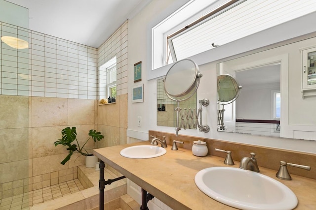 bathroom featuring double sink vanity, tasteful backsplash, and tile walls