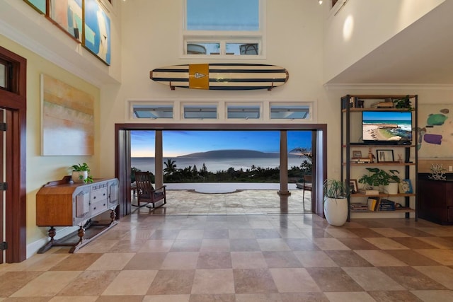 tiled entryway with a high ceiling