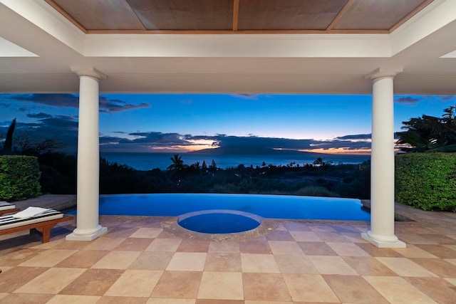 view of patio terrace at dusk