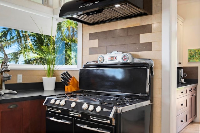 kitchen with custom range hood, backsplash, and a wealth of natural light