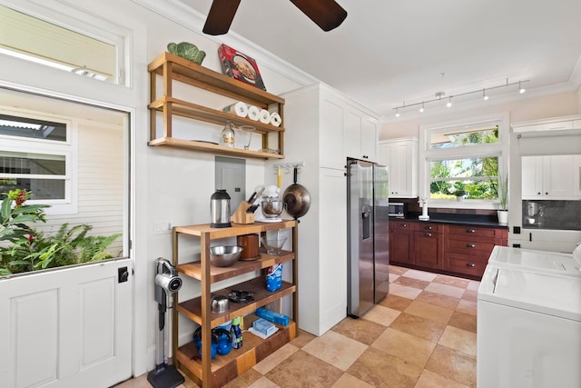 kitchen featuring independent washer and dryer, ceiling fan, stainless steel fridge with ice dispenser, rail lighting, and white cabinetry