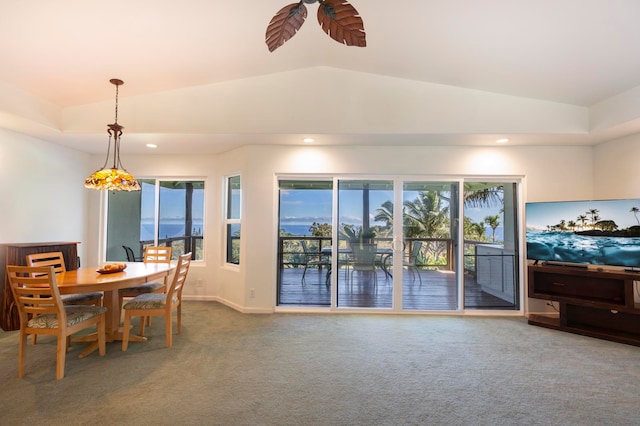 carpeted dining space featuring ceiling fan and lofted ceiling