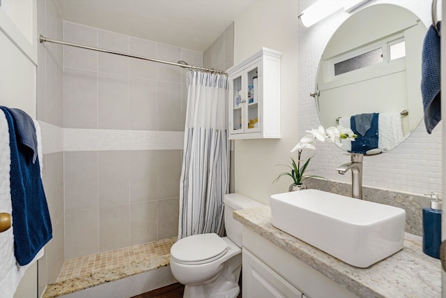 bathroom with toilet, vanity, and walk in shower