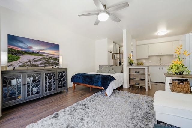 bedroom featuring dark wood-type flooring, ceiling fan, and sink