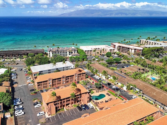 drone / aerial view featuring a beach view and a water view