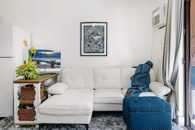 carpeted living room with an AC wall unit