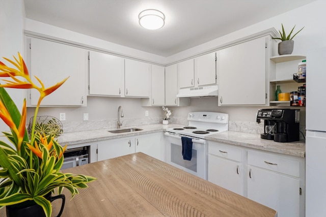 kitchen featuring white cabinets, light stone counters, sink, and white appliances