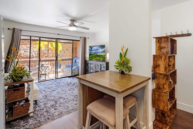 dining room with hardwood / wood-style flooring and ceiling fan