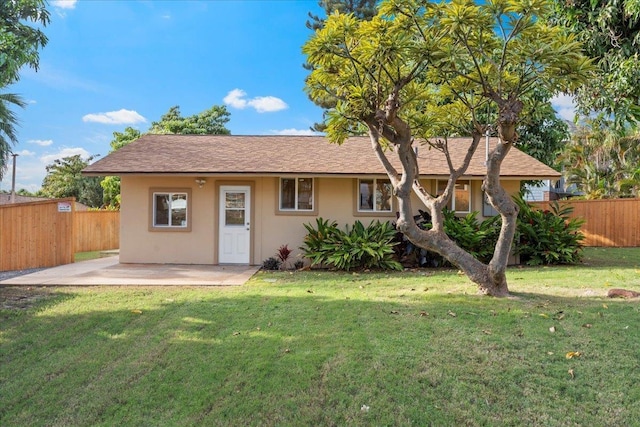 view of front facade featuring a front yard and a patio