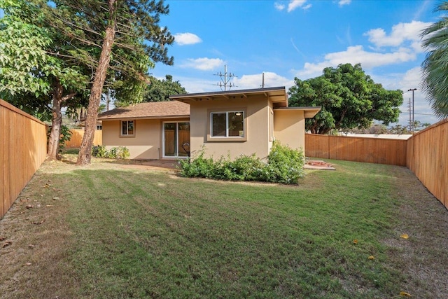 back of house with a lawn