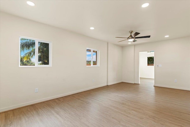 unfurnished room with ceiling fan and light hardwood / wood-style floors