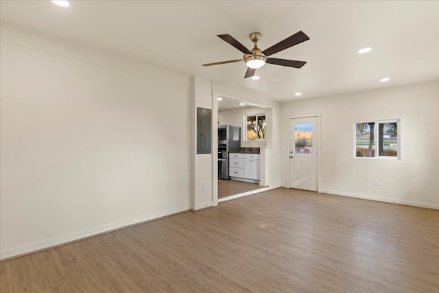 unfurnished living room with hardwood / wood-style floors and ceiling fan