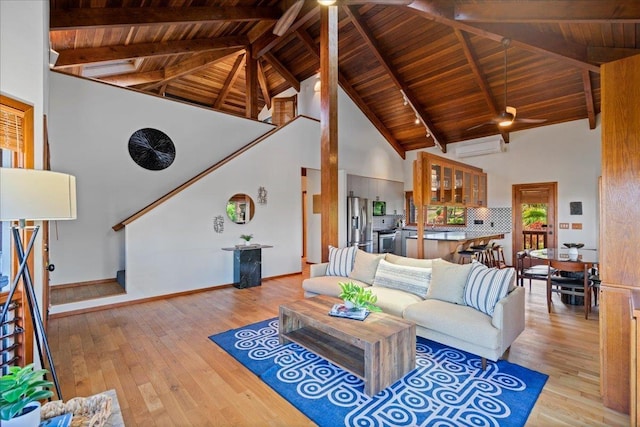 41 Pihaa St, Lahaina, HI 96761 - living area with ceiling fan, a wall unit AC, light wood-style floors, high vaulted ceiling, and a wood ceiling with exposed beams
