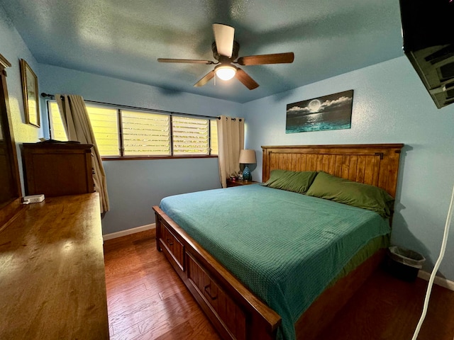 bedroom with ceiling fan and dark hardwood / wood-style floors