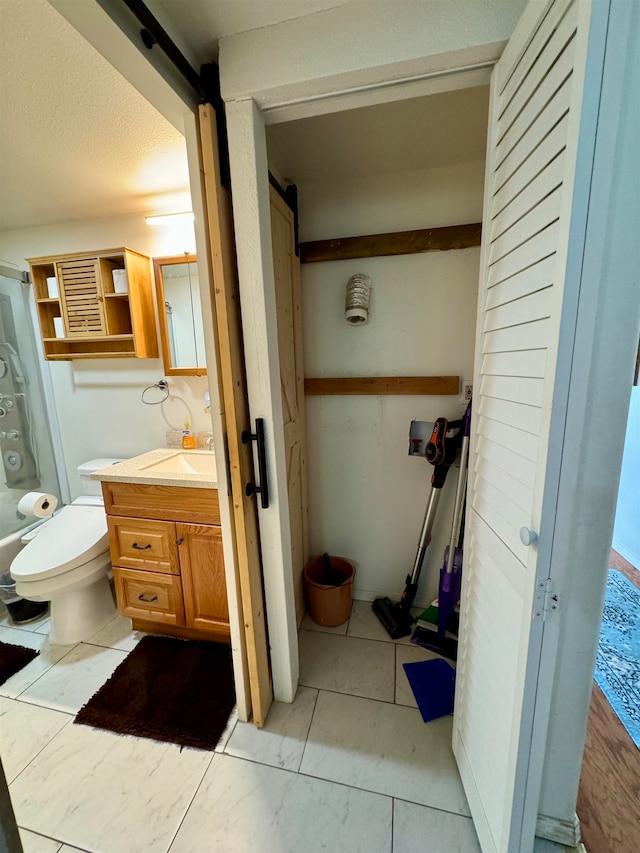 bathroom with toilet, tile patterned flooring, and vanity