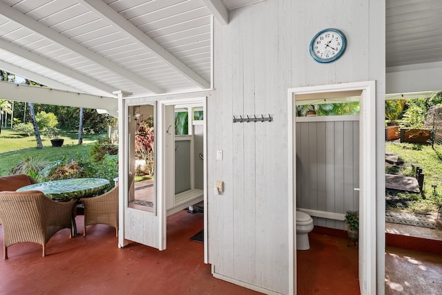 sunroom with lofted ceiling with beams