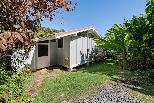 view of outbuilding featuring a lawn