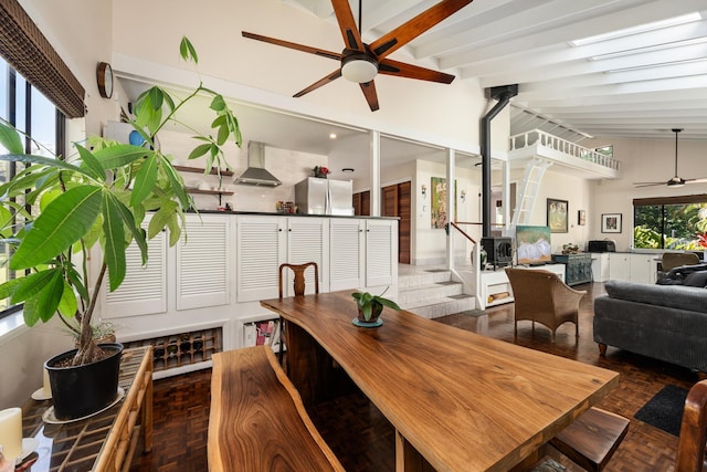 dining area with vaulted ceiling with beams, ceiling fan, and dark parquet flooring