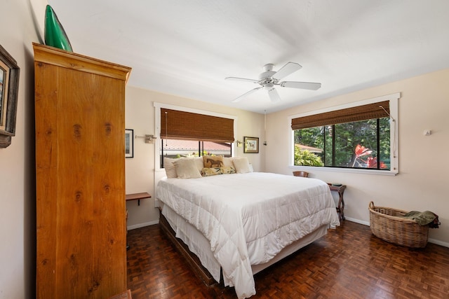 bedroom with dark parquet floors and ceiling fan