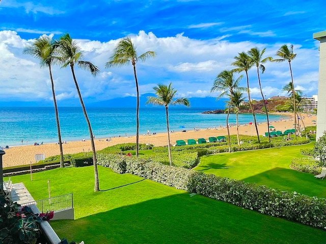 surrounding community featuring a yard, a beach view, and a water view