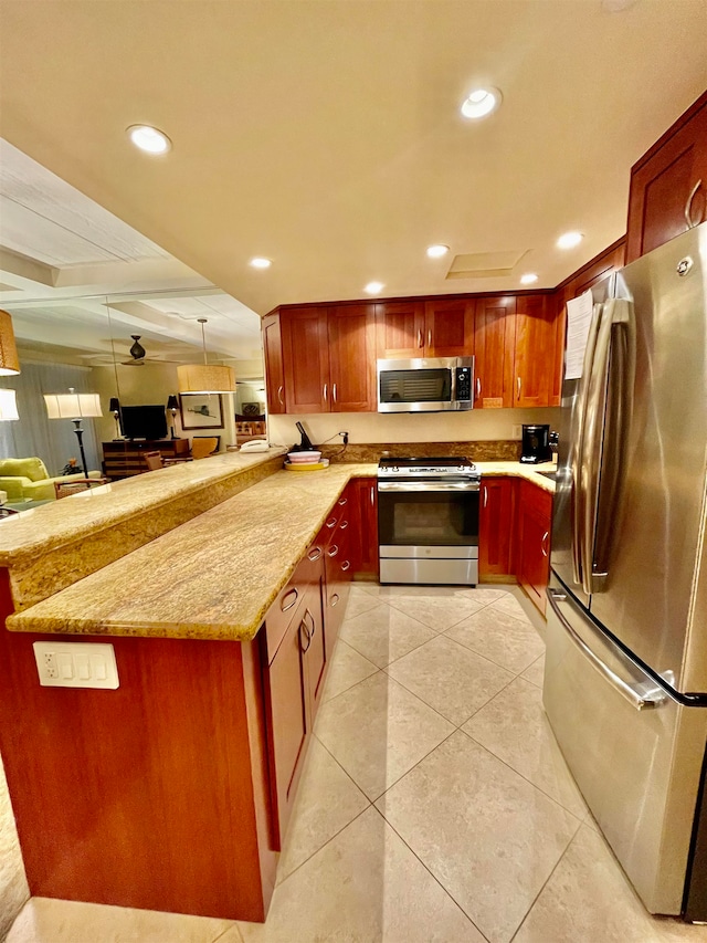 kitchen with pendant lighting, appliances with stainless steel finishes, light tile floors, and light stone counters