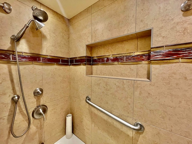 bathroom with tiled shower