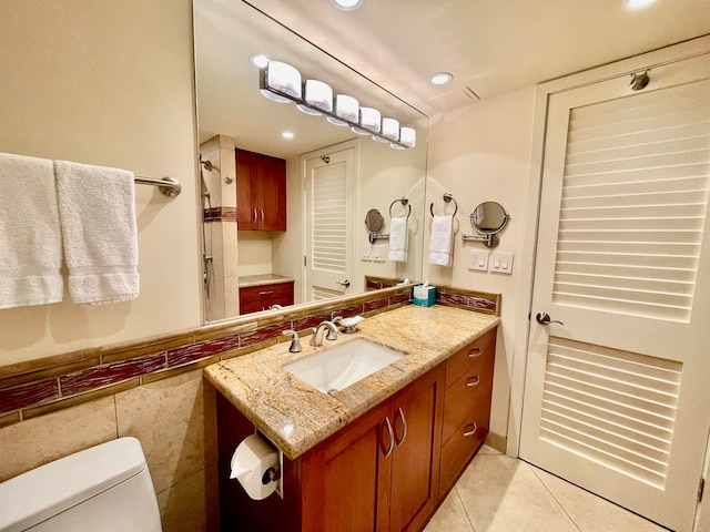 bathroom featuring toilet, tile floors, and oversized vanity