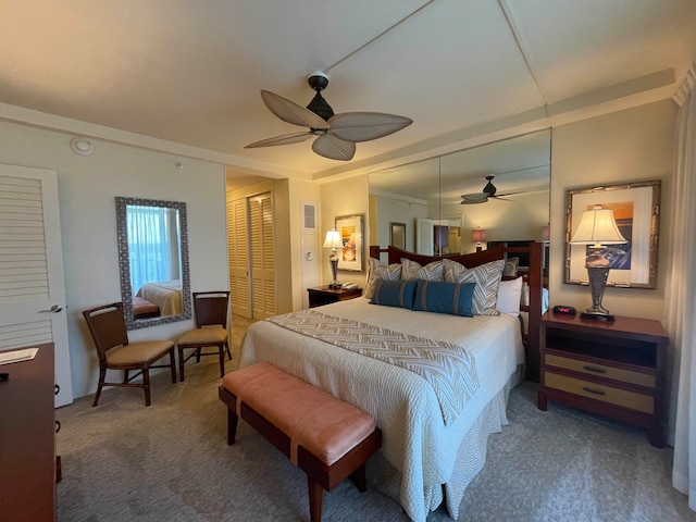bedroom with ceiling fan and dark colored carpet