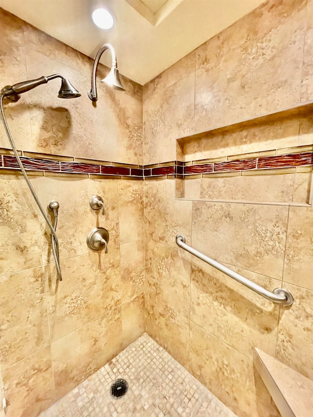 bathroom with a tile shower